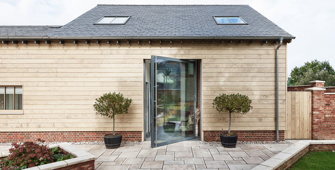 Exterior view of Ellingham Barns - a barn conversion project in Dorset, by INKSPACE Architects and Interior
