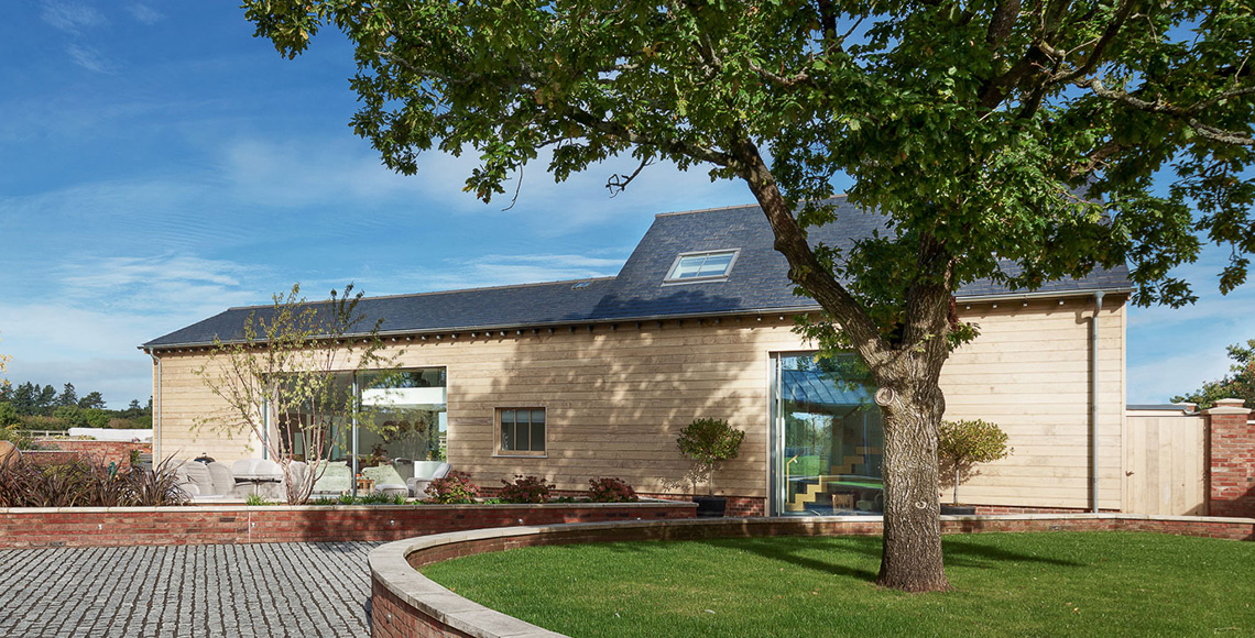 Garden and tree outside Ellingham Barns - a three-barn conversion project in Dorset, by INKSPACE Architects and Interiors