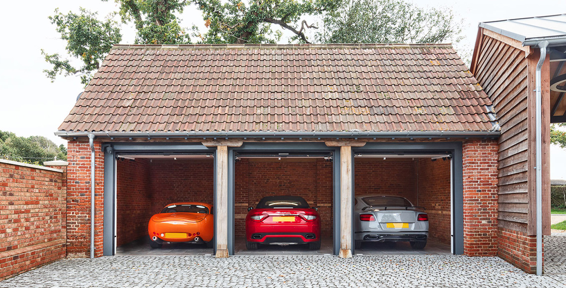 Newly constructed parking garages besides Ellingham Barns - a three-barn conversion project in Dorset, by INKSPACE Architects and Interiors