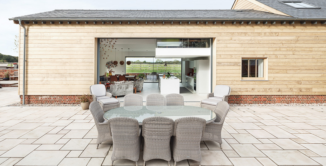 Outside dining area of Ellingham Barns - a barn conversion project in Dorset, by INKSPACE Architects and Interior
